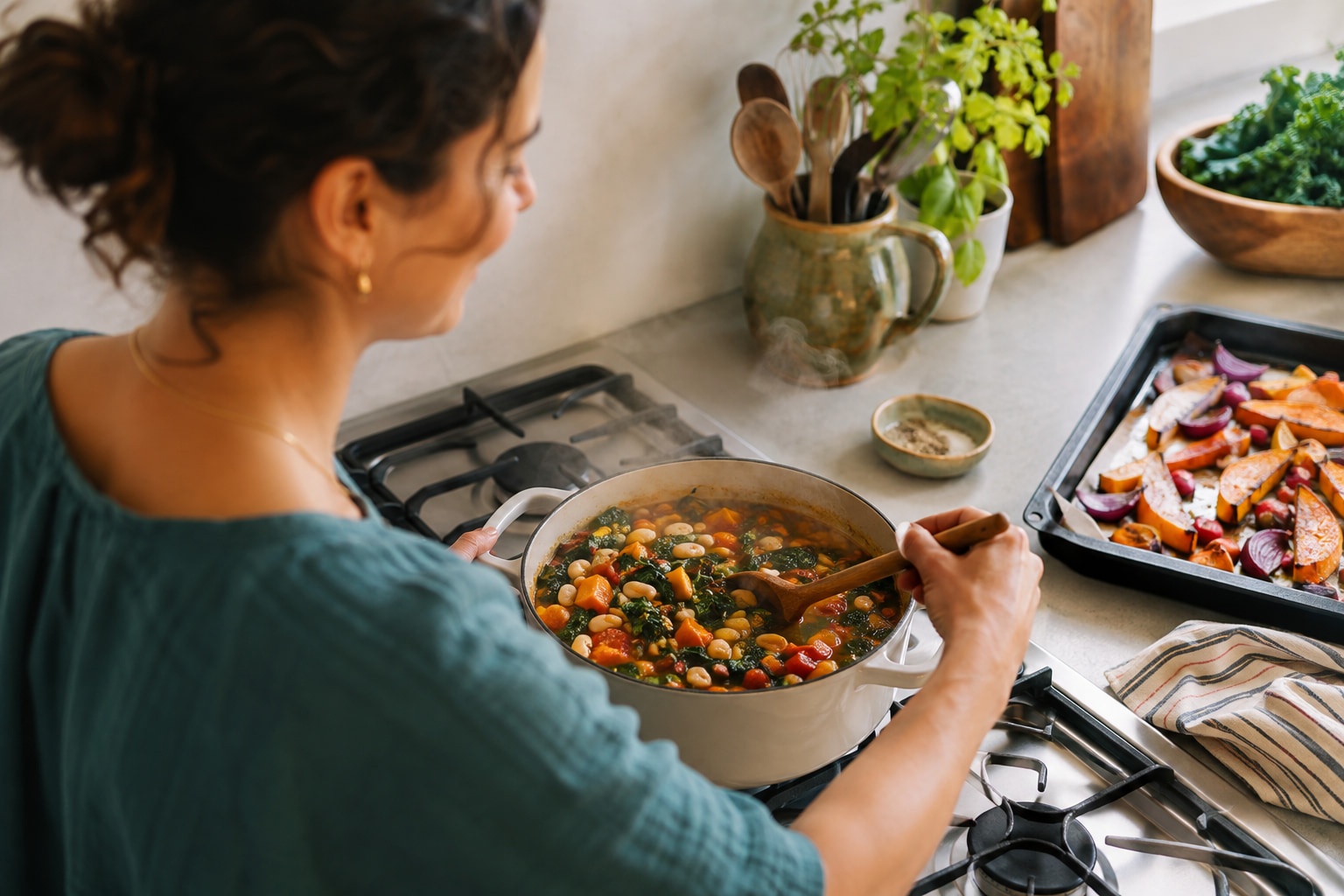 A home cook prepares vegetable-and-bean stew beside a small tray of roasted vegetables.